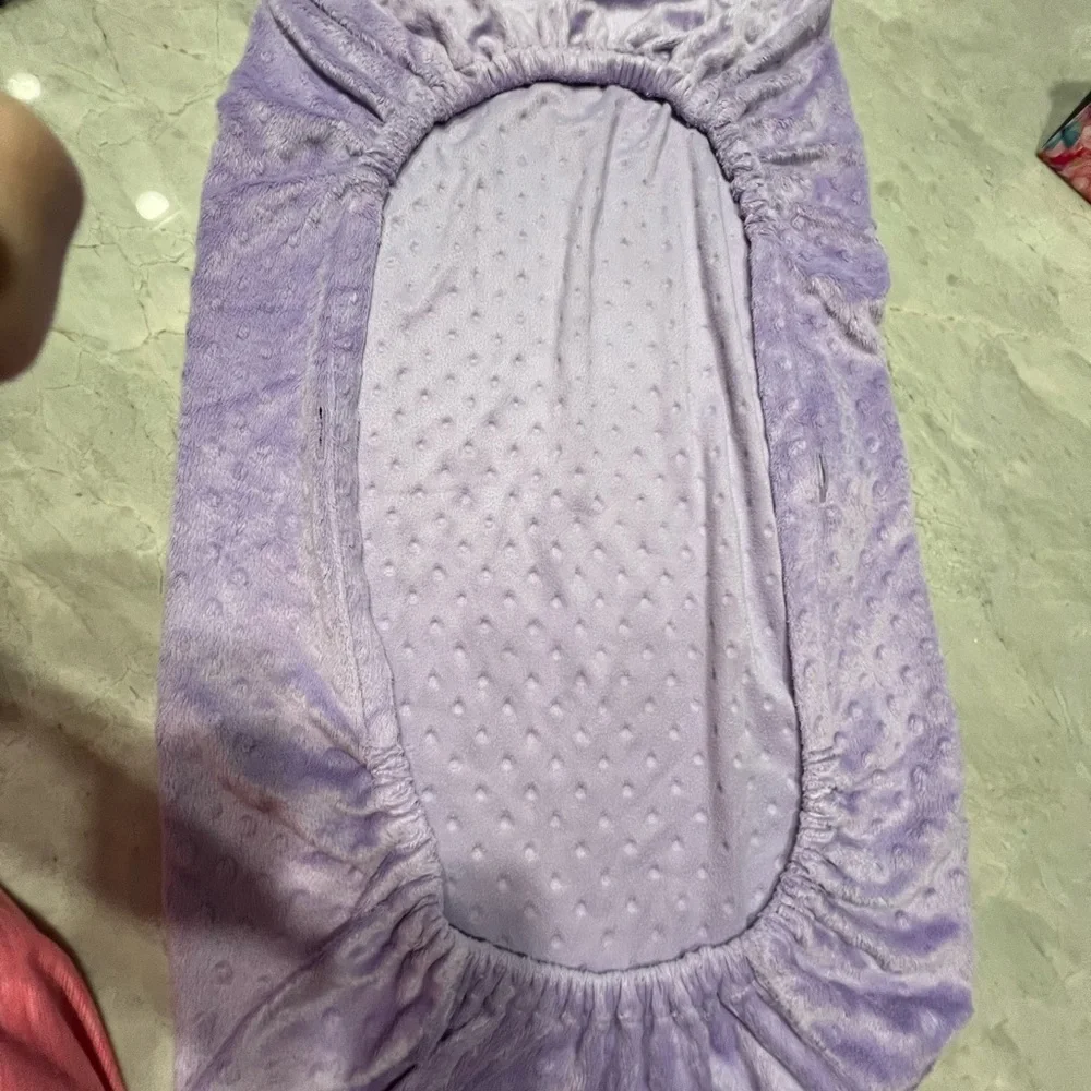 Source Unknown - Purple changing pad cover and White polka dot blanket.